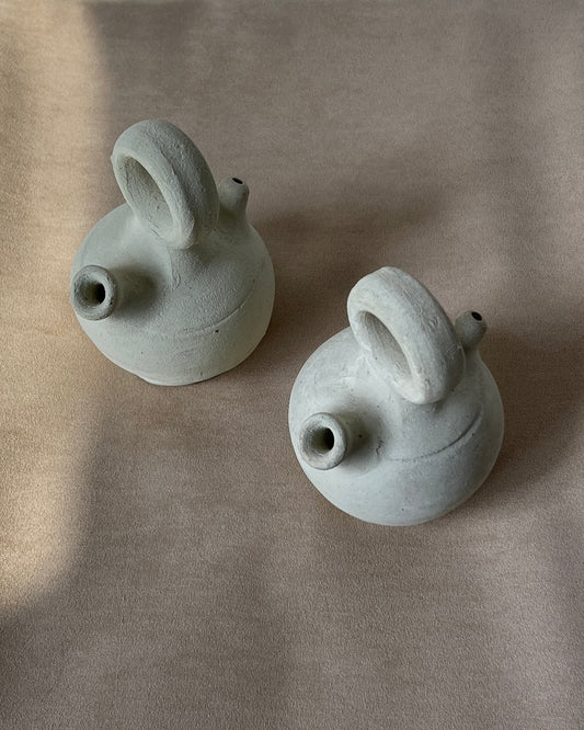 Close-up detail of the unglazed natural clay texture on a 1970s Spanish mini botijo, revealing fine porous surface and subtle age-related patina, ideal for collectors seeking authentic mid-century pottery and traditional water-cooling design.