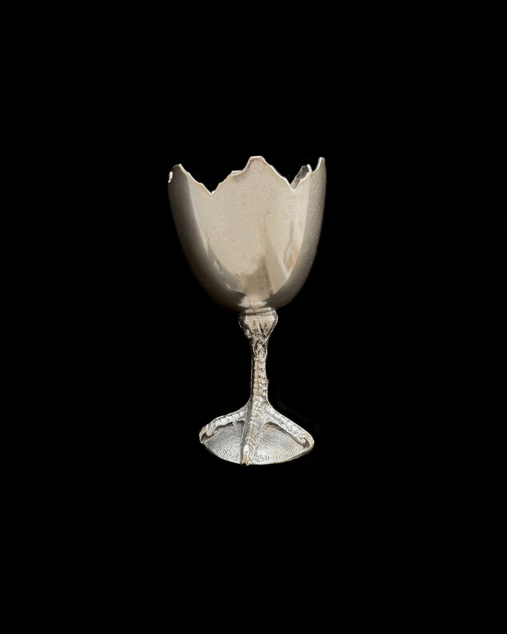 The base of the egg cup showing the realistic chicken claw design, crafted from durable Alpaca silver with a beautiful vintage patina.