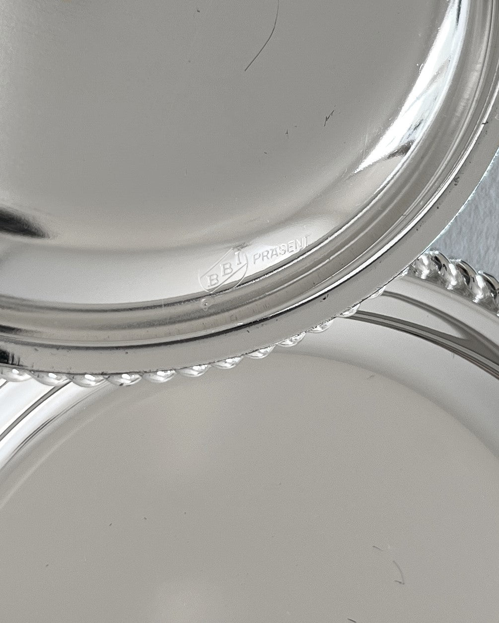 The underside of a coaster showing the iconic BBI Präsent hallmark, confirming the authenticity and high-quality German manufacturing of the piece.