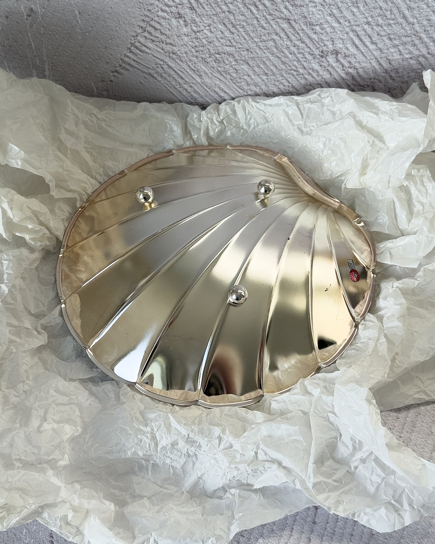 A sculptural view of the BMF shell dish, emphasizing the Art Deco revival geometry and Hollywood Regency glamour of this German silverplate piece.