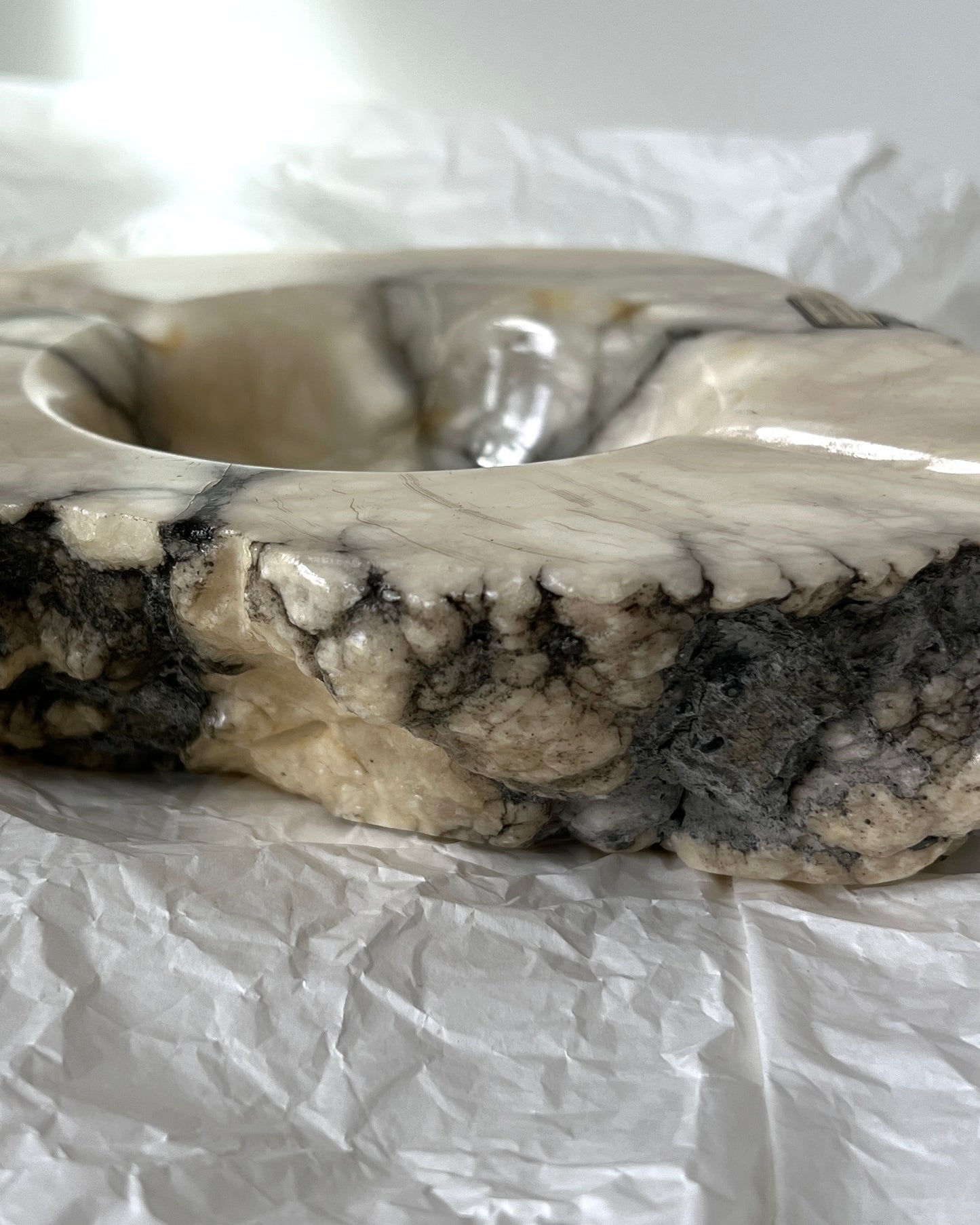 The solid weight and organic form of this large collectible Italian marble ashtray, a true piece of vintage craftsmanship.