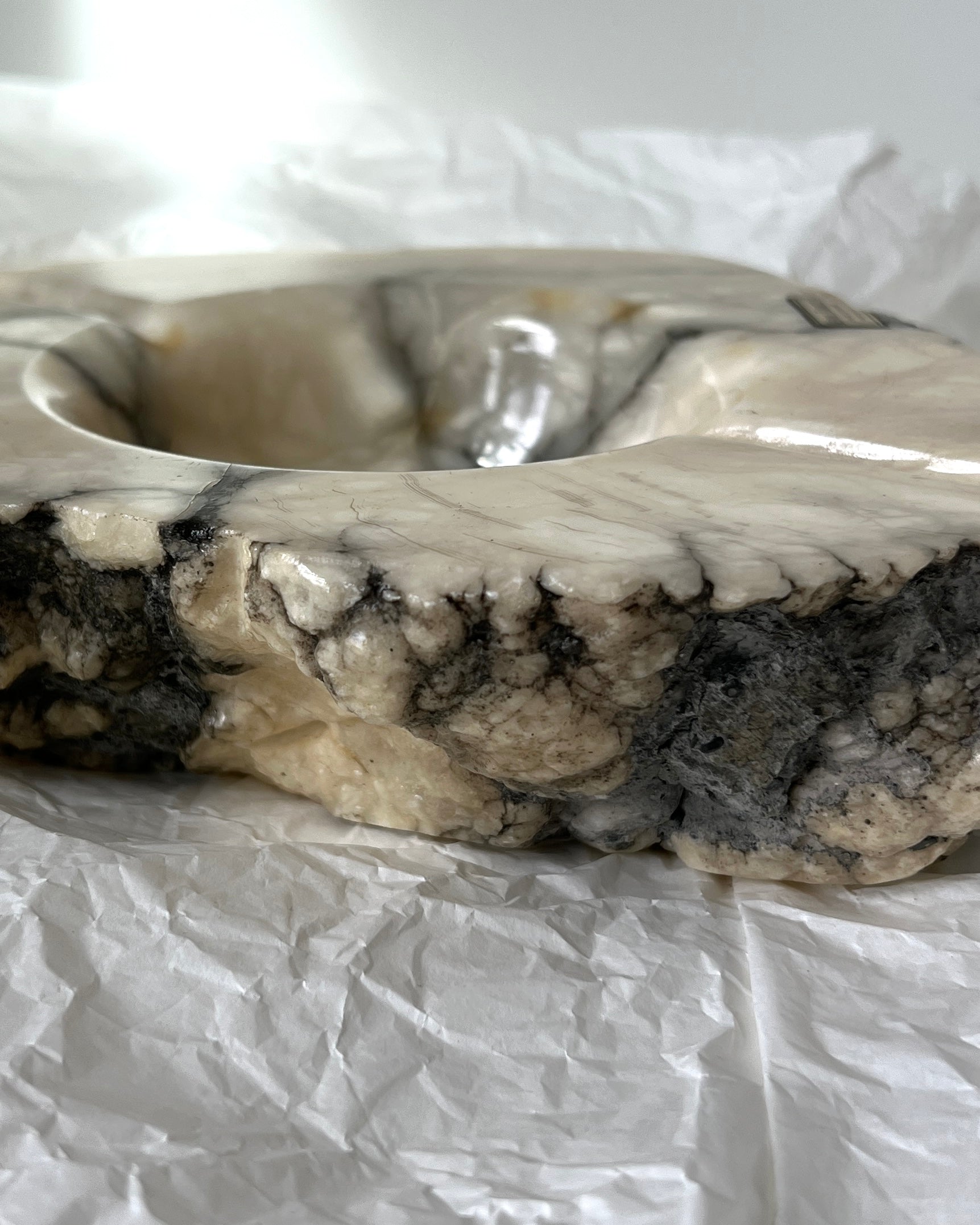 The solid weight and organic form of this large collectible Italian marble ashtray, a true piece of vintage craftsmanship.