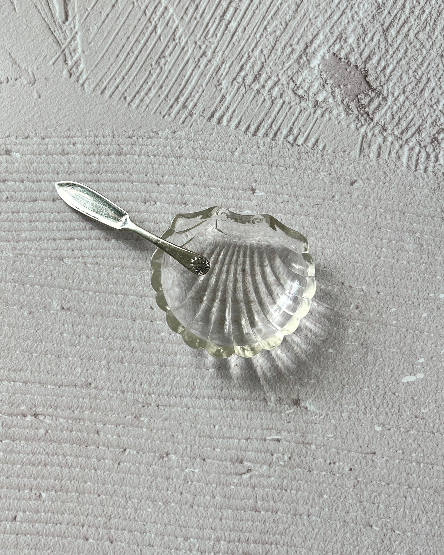 Detailed view of the intricate chrome-plated finish and artistry of the vintage Sheffield silver shell serving dish, a testament to English craftsmanship.