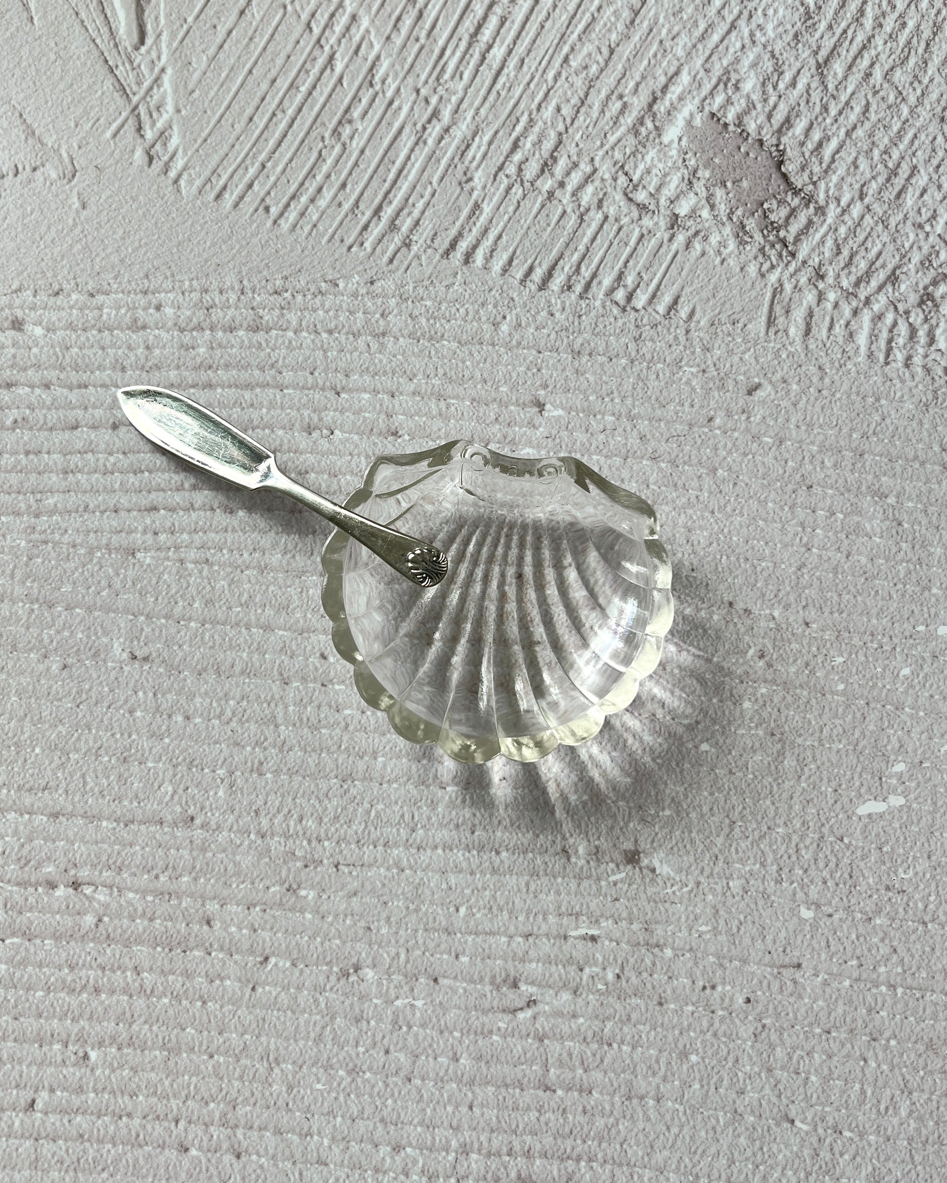 Detailed view of the intricate chrome-plated finish and artistry of the vintage Sheffield silver shell serving dish, a testament to English craftsmanship.