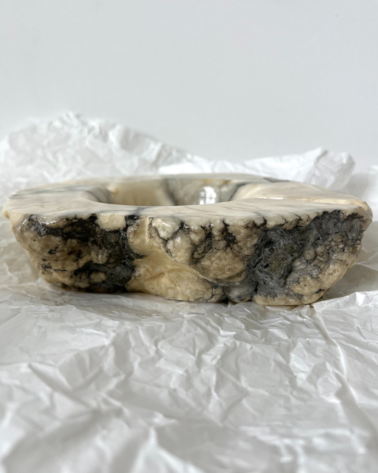 Original "Genuine Alabaster Hand Carved Made in Italy" label on the base of the vintage brutalist ashtray, confirming its authenticity.