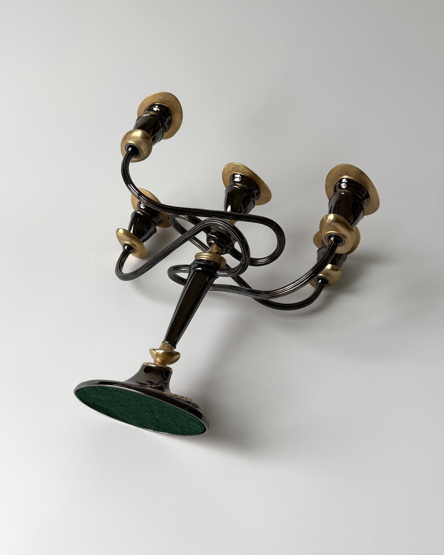 Close-up of the substantial, heavyweight metal base of the candelabra, illustrating its durable build and 1980s design heritage.