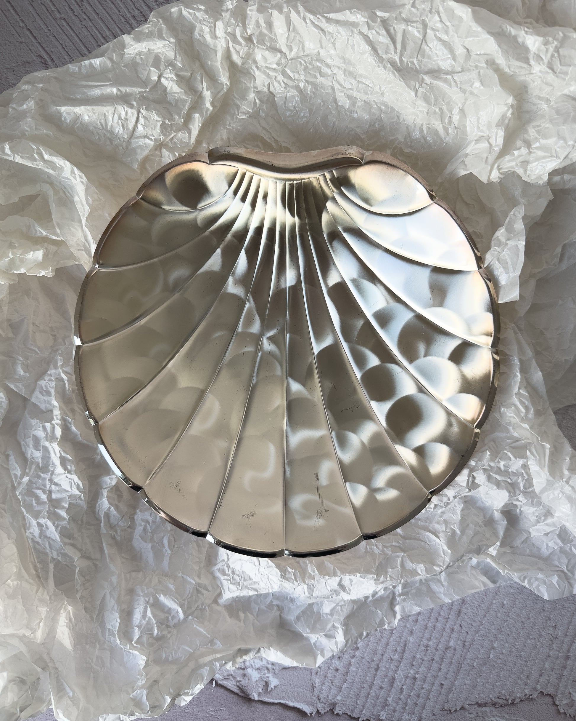 A large vintage BMF silver-plated ikora shell centerpiece from West Germany, featuring a dramatic scallop silhouette and high-polish mirror finish.