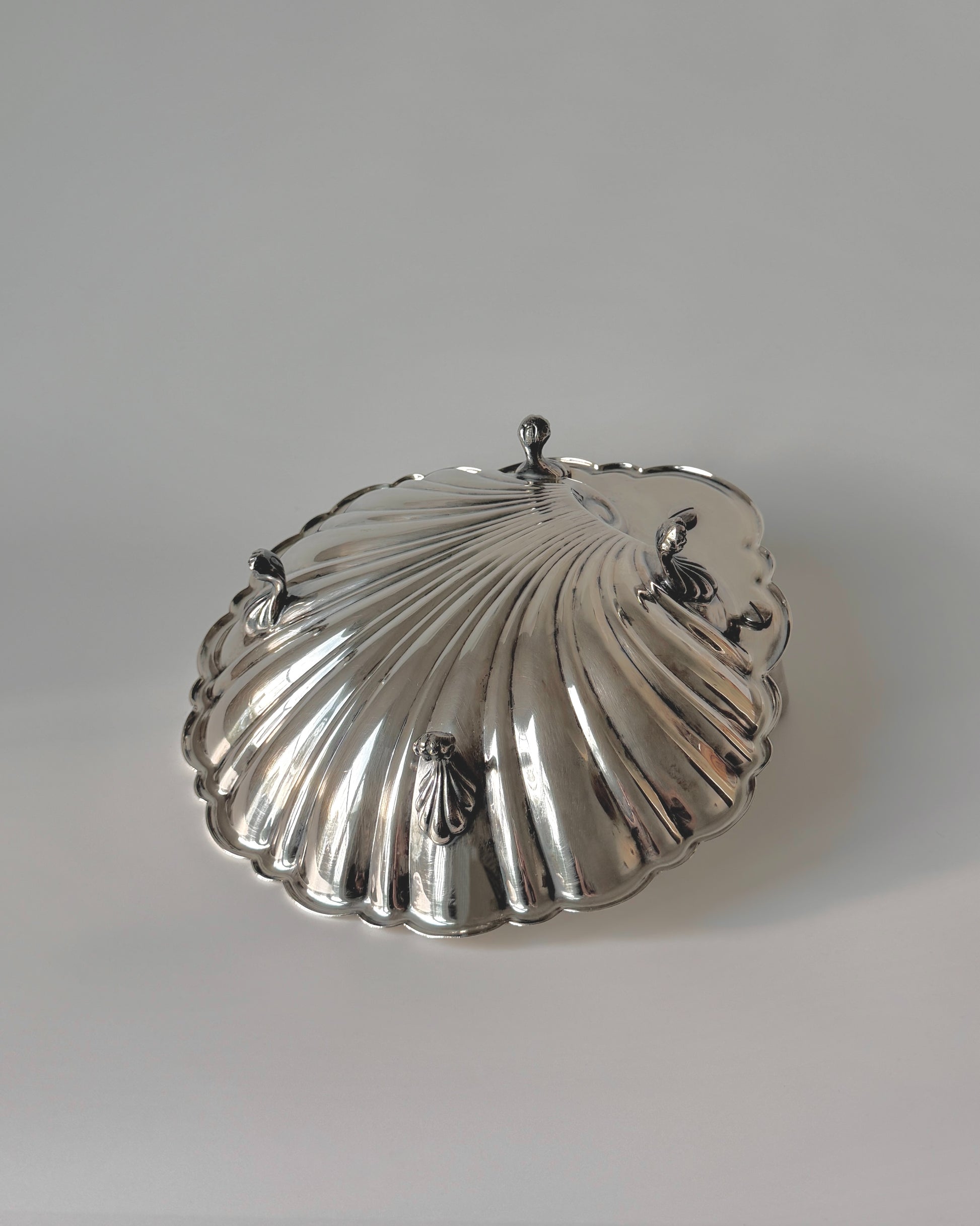 Top-down view of the large silver-plated scallop shell bowl, ideal for serving shrimp cocktails on ice or acting as a decadent fruit bowl.