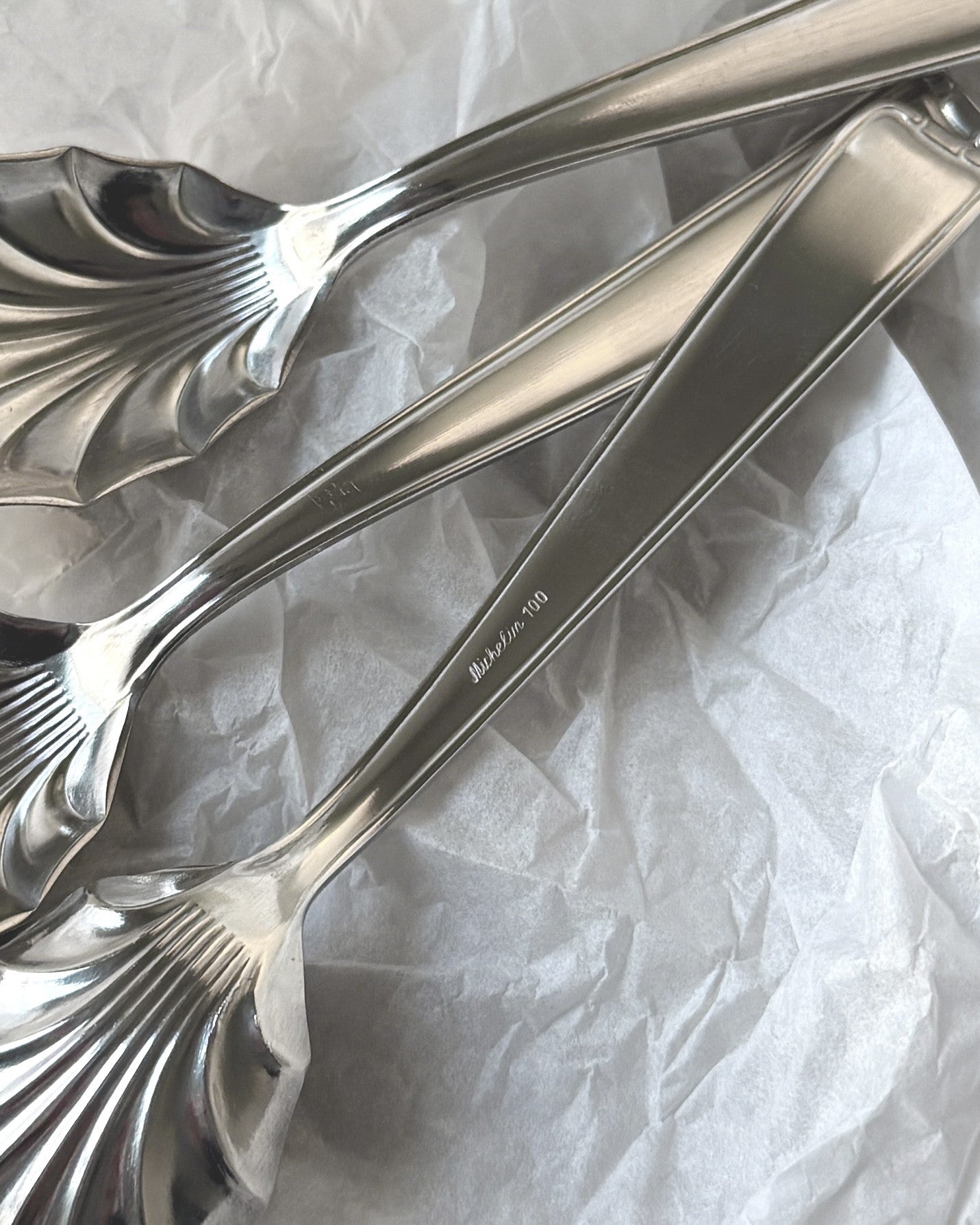 Zoomed-in shot of the reverse of three Michelin spoons showing the authentic Michelin 100 hallmark, verifying high-quality German silver plating.