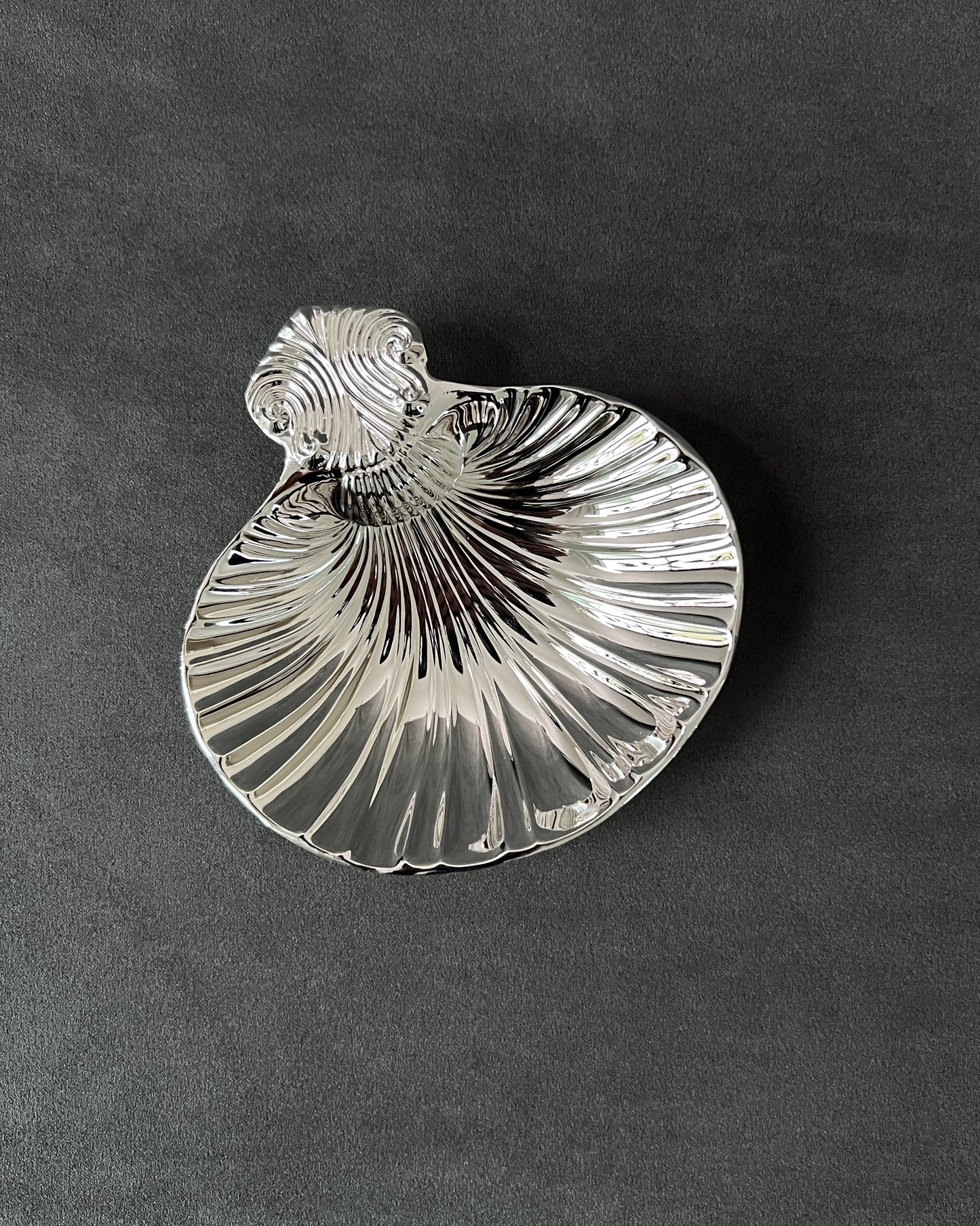 Vintage silver-plated shell dish holding caviar, demonstrating functional use as elegant server for appetizers and desserts.