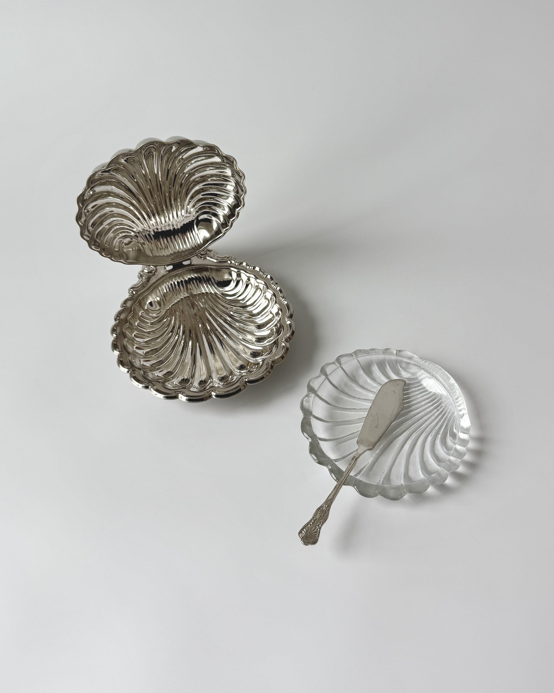 The silver-plated shell dish shown with the removable clear glass insert, ideal for serving chilled caviar on ice or creamy butter.