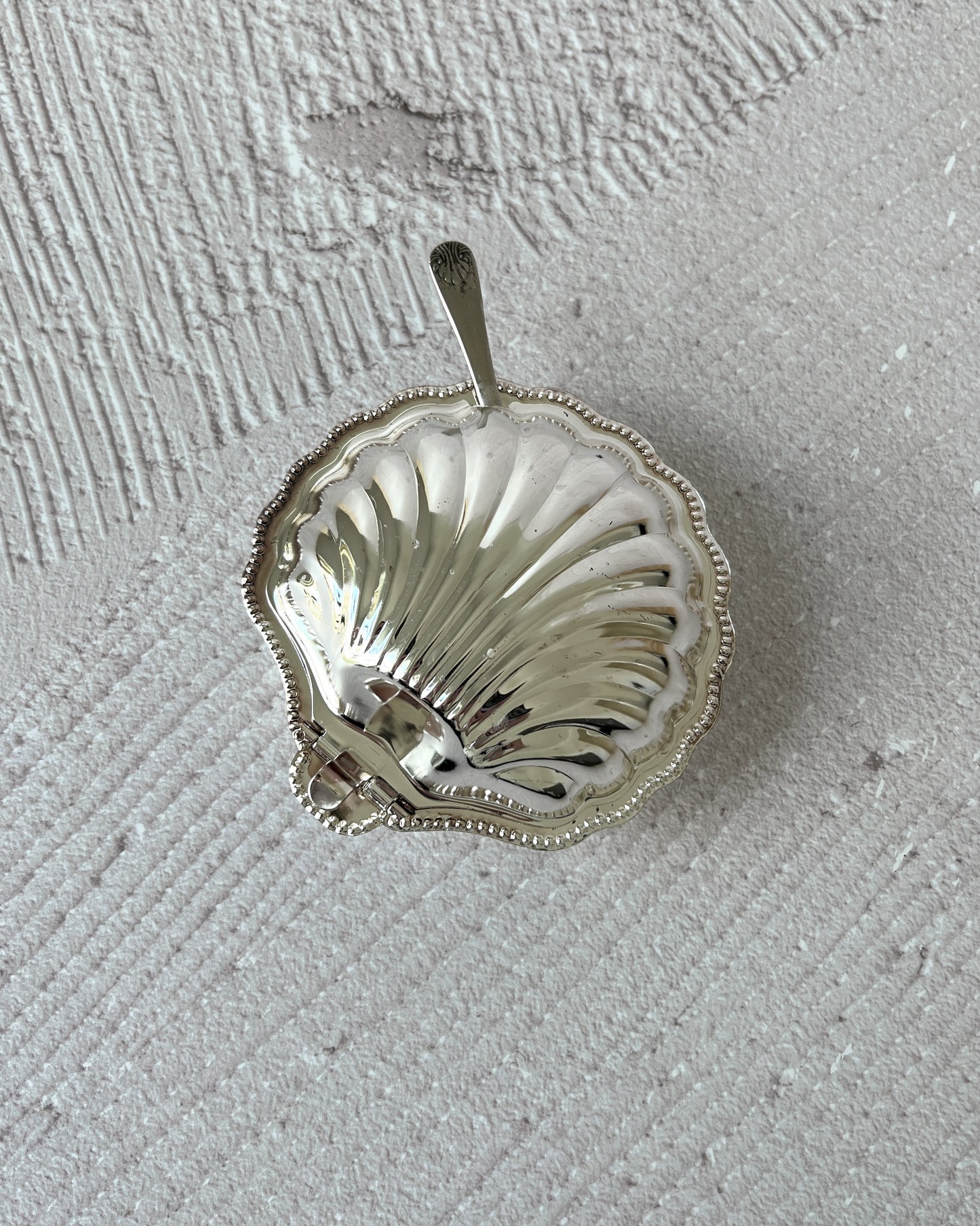 Vintage Sheffield silver-plated shell dish used as a beautiful decorative holder for jewelry, highlighting its versatility beyond serveware.