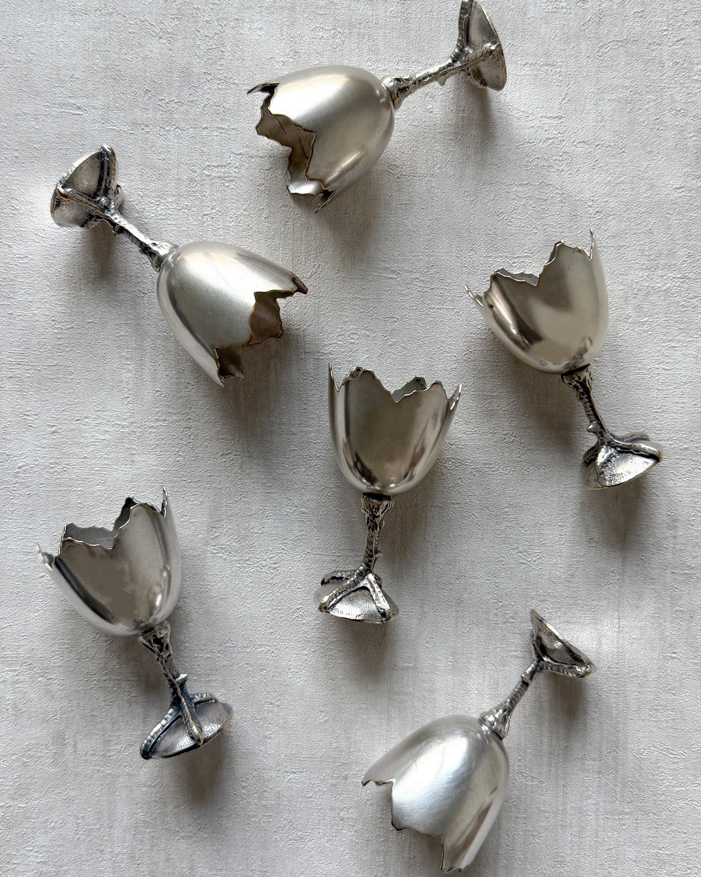 A side profile of the nickel silver egg cup, highlighting its unique architectural silhouette and playful mid-century modern aesthetic.
