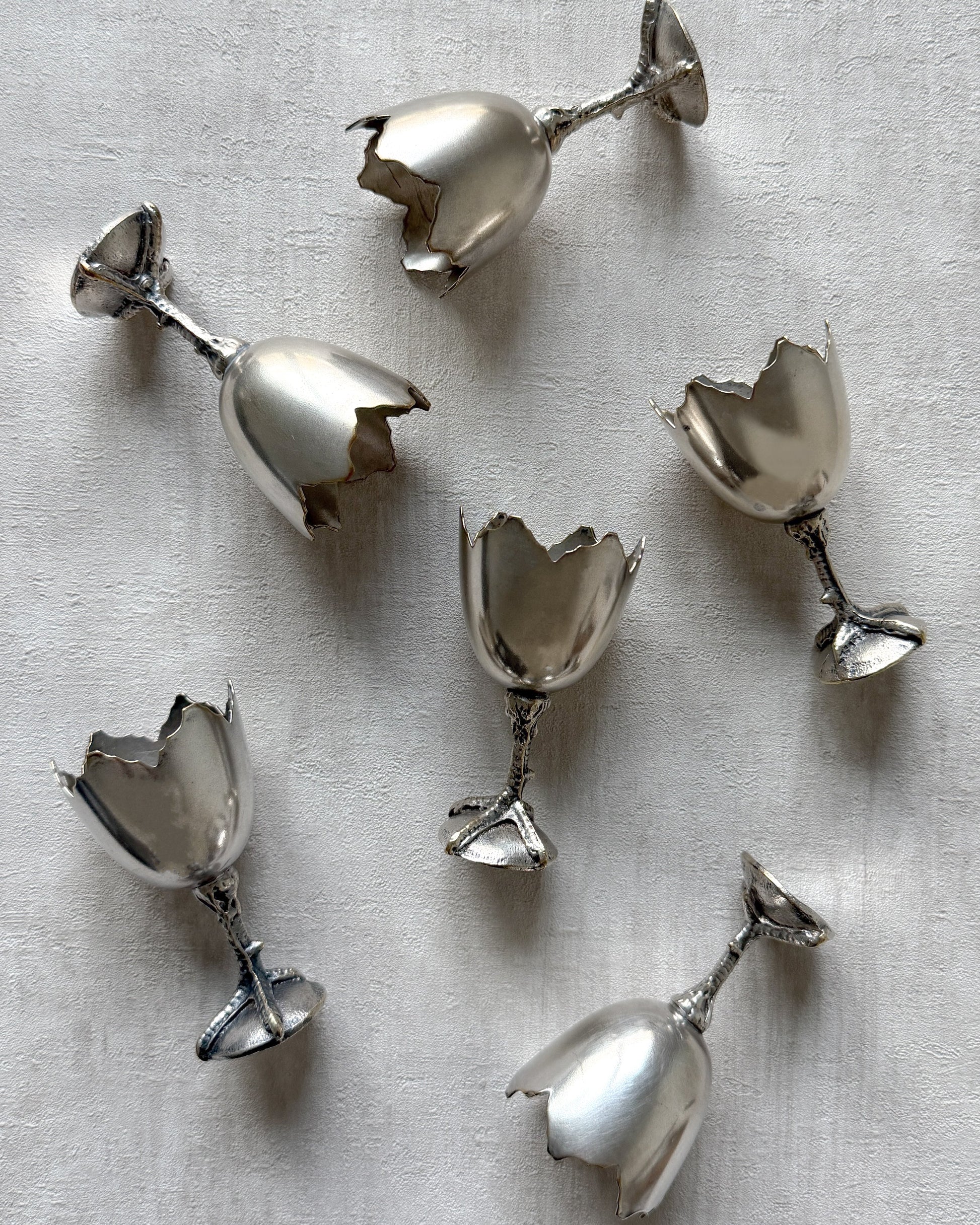 A side profile of the nickel silver egg cup, highlighting its unique architectural silhouette and playful mid-century modern aesthetic.