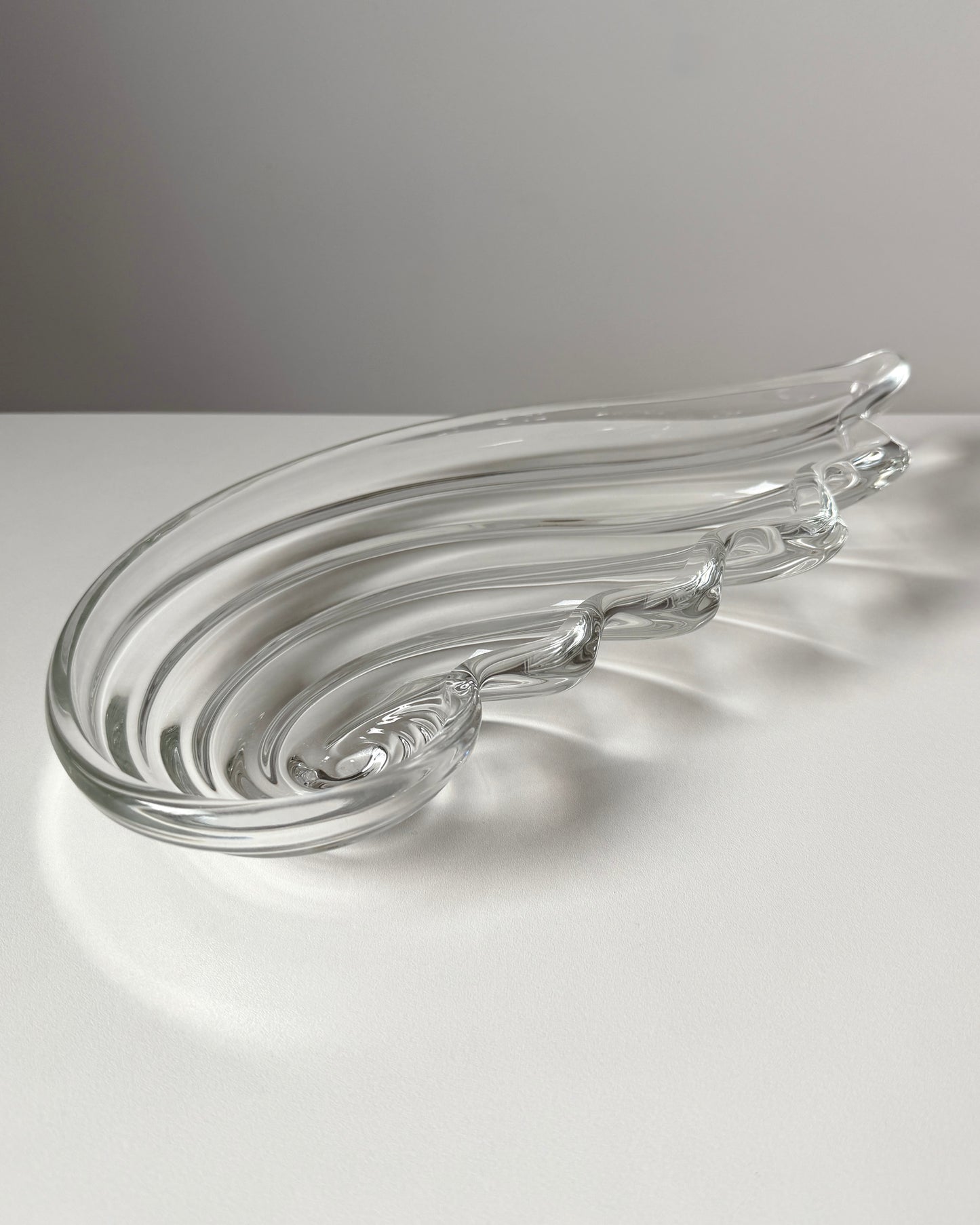 An angled perspective of the heavy nautilus shell bowl, showcasing its substantial depth and the high-quality "heft" of 1980s German crystal.