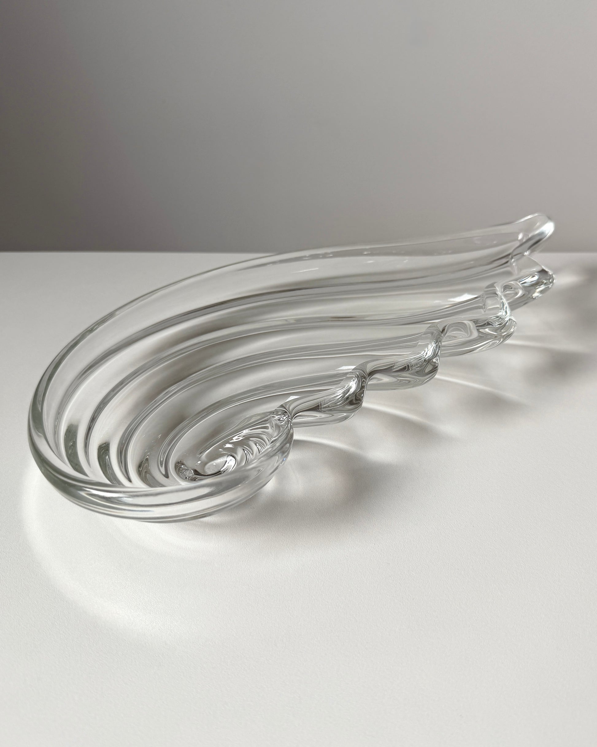 An angled perspective of the heavy nautilus shell bowl, showcasing its substantial depth and the high-quality "heft" of 1980s German crystal.