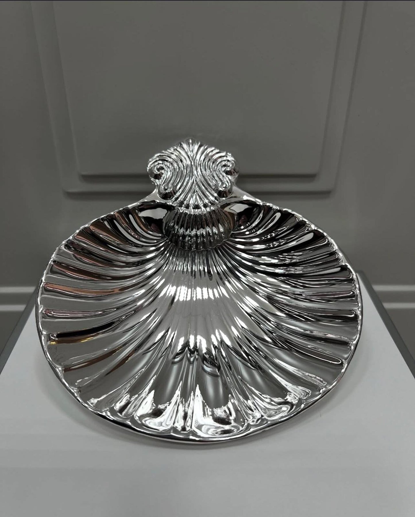 Vintage shell dish displayed on bathroom sink as soap dish, illustrating seaside-inspired décor in modern home setting.