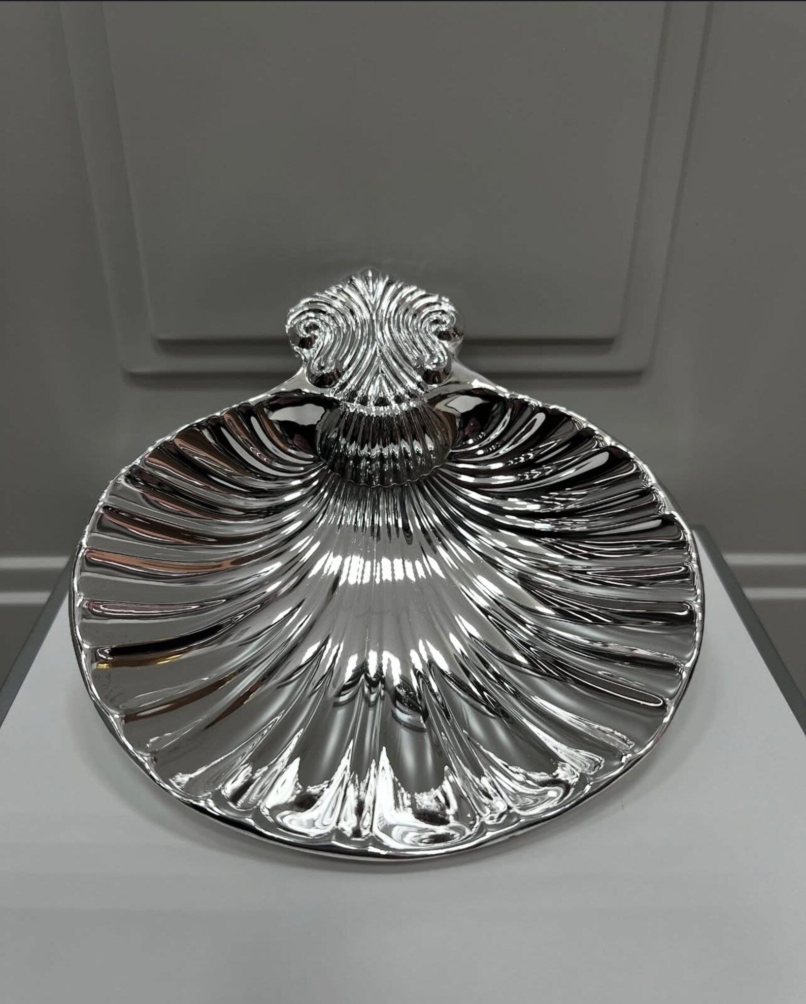 Vintage shell dish displayed on bathroom sink as soap dish, illustrating seaside-inspired décor in modern home setting.