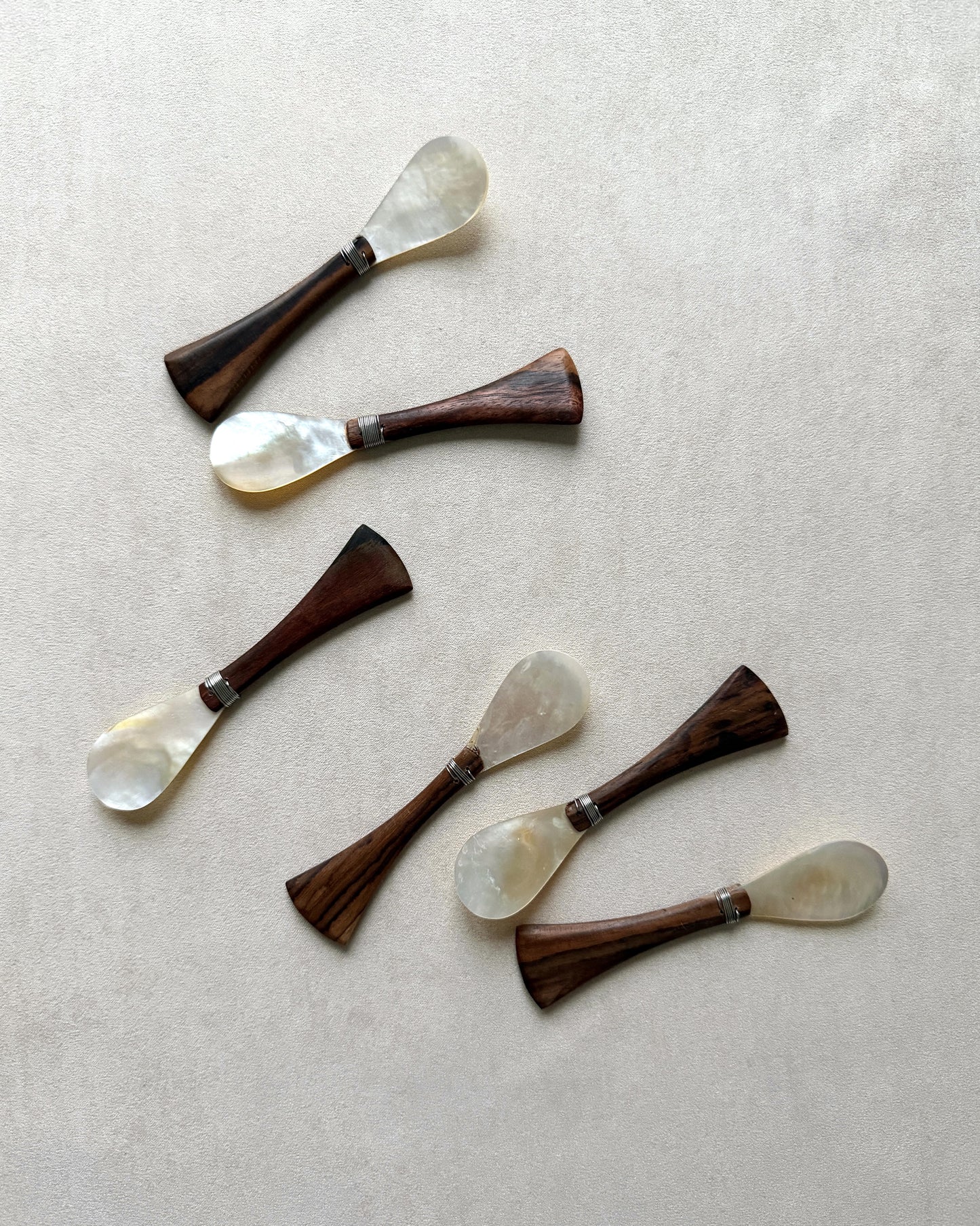 Six vintage mid-century modern serving spoons handcrafted from durable teak and non-reactive mother-of-pearl, showcasing a clean minimalist silhouette.