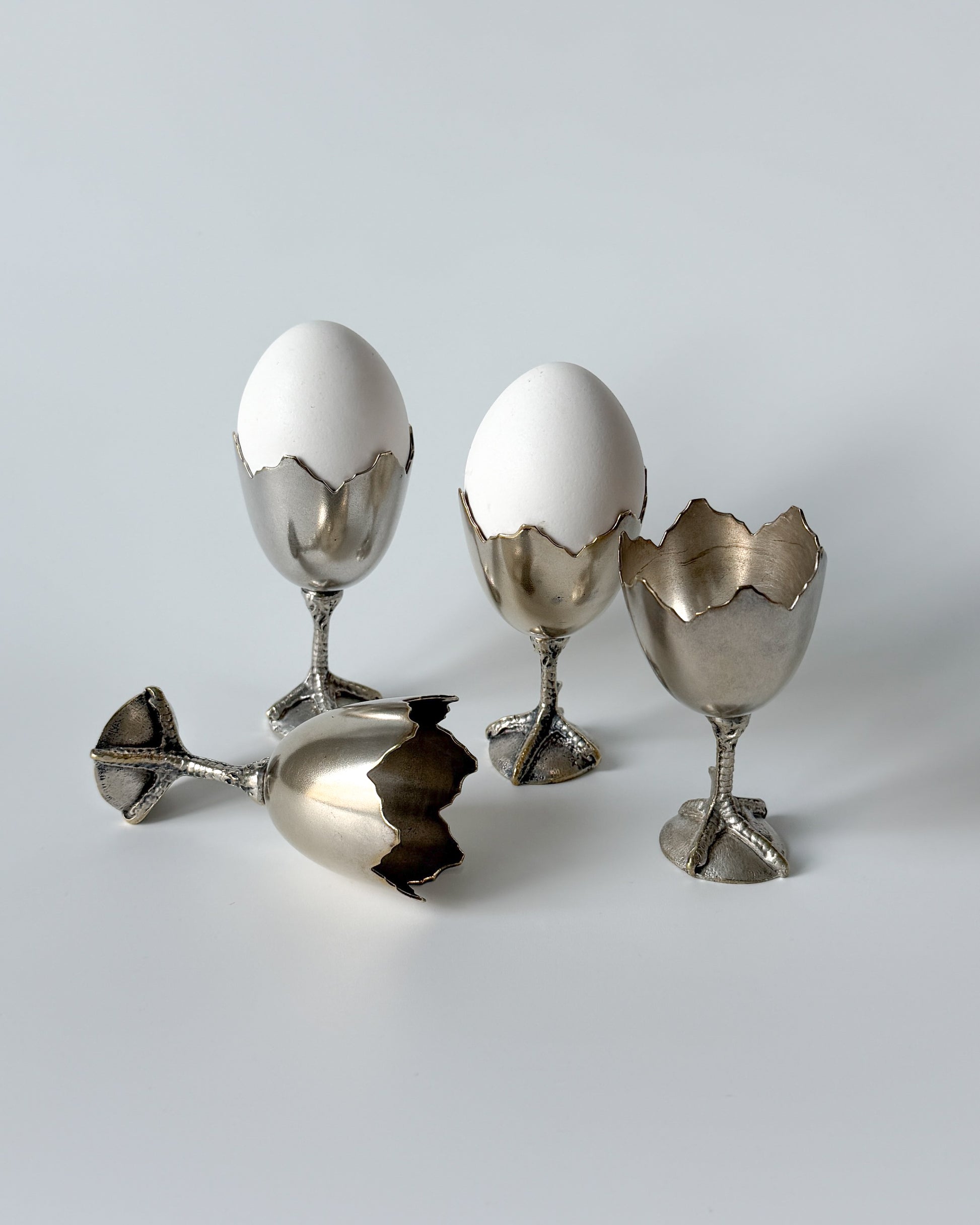 An angled view of the whimsical chicken foot egg cup, perfect as a conversation starter for an eclectic grandmillennial brunch or a vintage curiosities cabinet.
